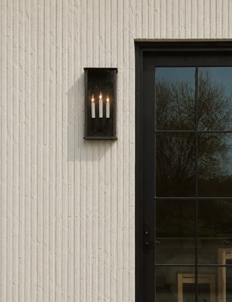 Qianmo stone texture linear flexible stone cladding beside a black framed entrance door and wall light