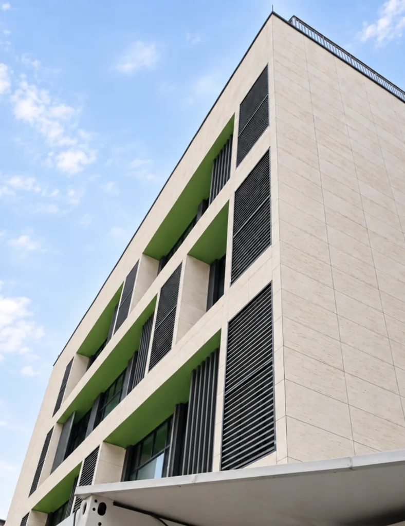 Modern building facade finished with light beige travertine-look flexible stone panels