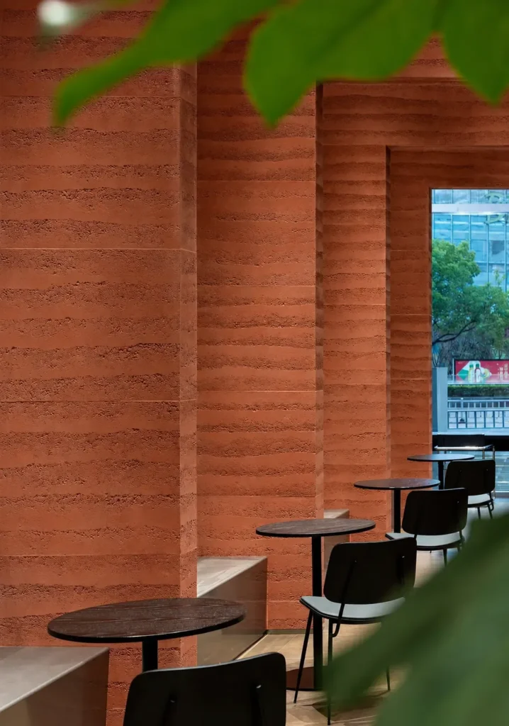 Clay Red Solid Color Rammed Earth walls in a modern café interior with layered earthen texture
