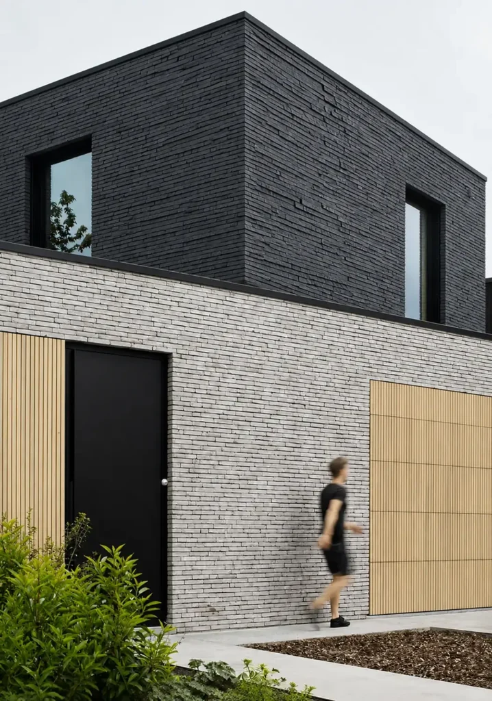Graphite Current and Ivory Stream Flowing Stone Texture used on a modern residential facade with layered linear stone cladding