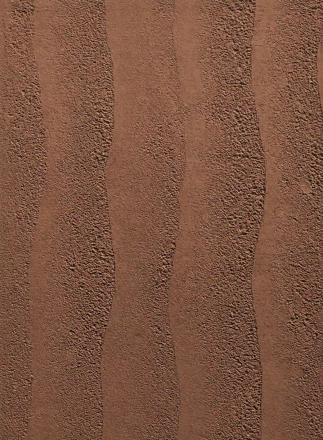 Brick brown rammed earth surface with broad organic vertical layers | YITA