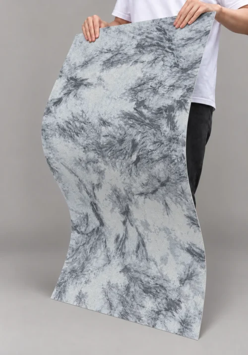Silver Bloom Flexible Marble Texture Detail | YITA Silver Bloom Marble Texture flexible sheet bent to show flowing gray mineral pattern and thin curved form