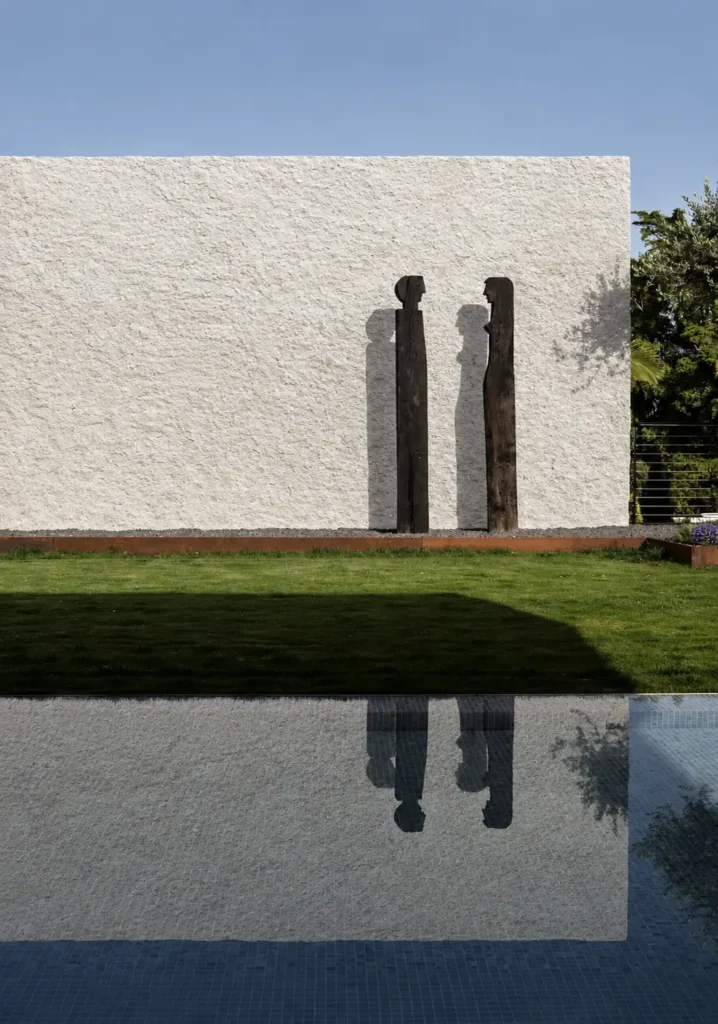 White Granite Texture applied to an outdoor landscape wall beside a pool and garden