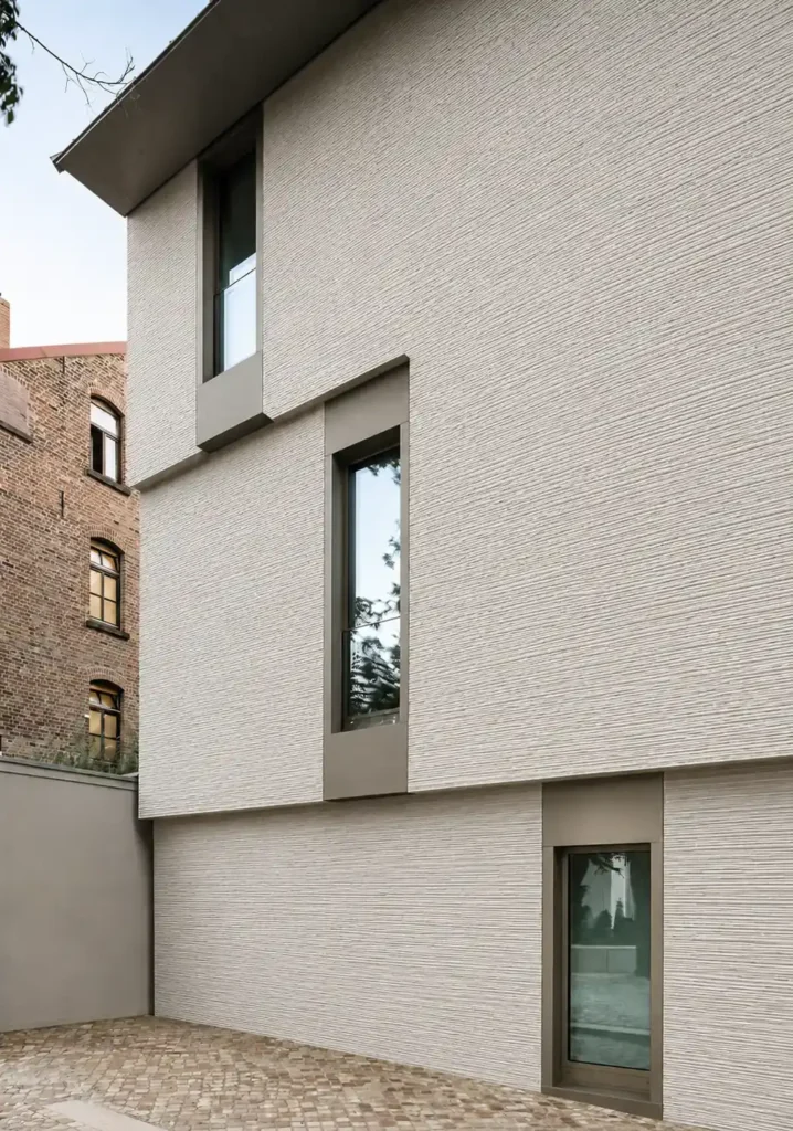 White linear stone veneer applied on a modern building facade with subtle textured wall surface