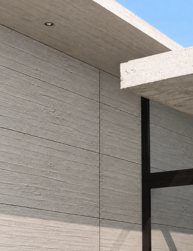 Gray cast wood grain flexible stone facade with horizontal board-formed concrete texture