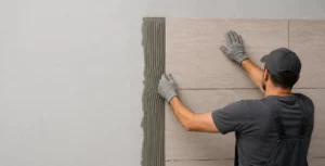 Flexible stone veneer installation with adhesive applied on wall substrate