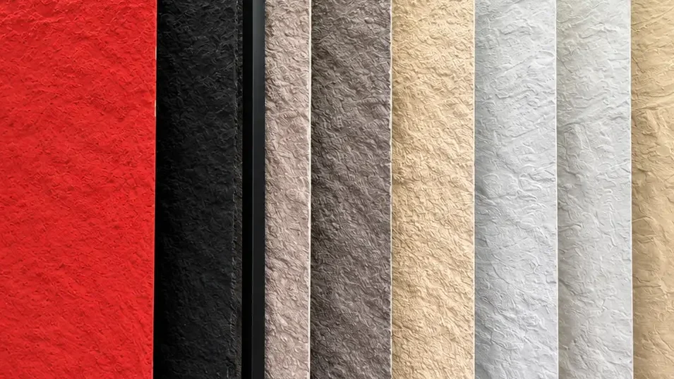 Vertical flexible stone panels in different colors and surface textures displayed in a showroom