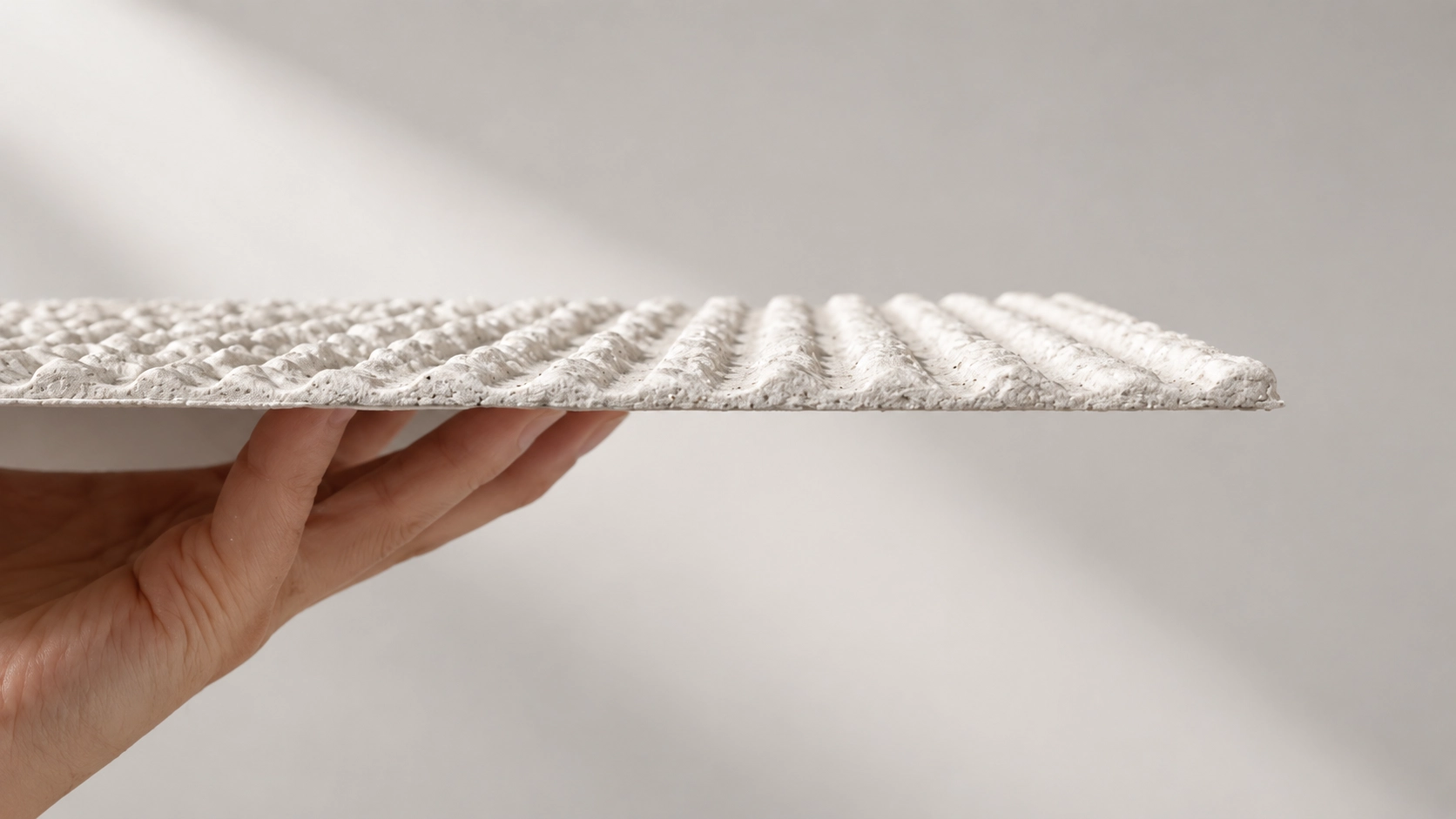 Side view of a thin flexible stone panel showing its profile and textured surface