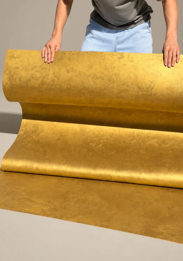 Golden silk metallic flexible stone sheet shown in a rolled display