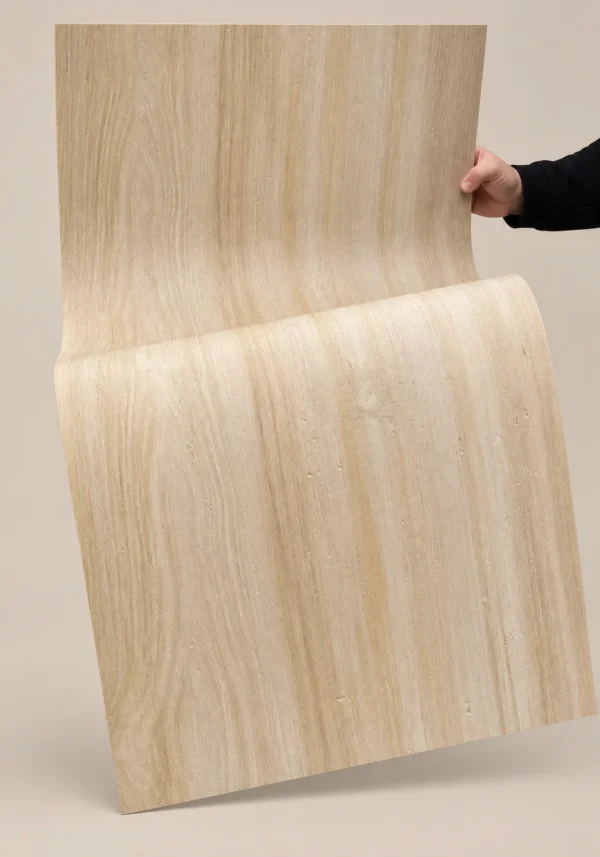 Natural wood grain flexible stone sheet bent by hand to show material flexibility