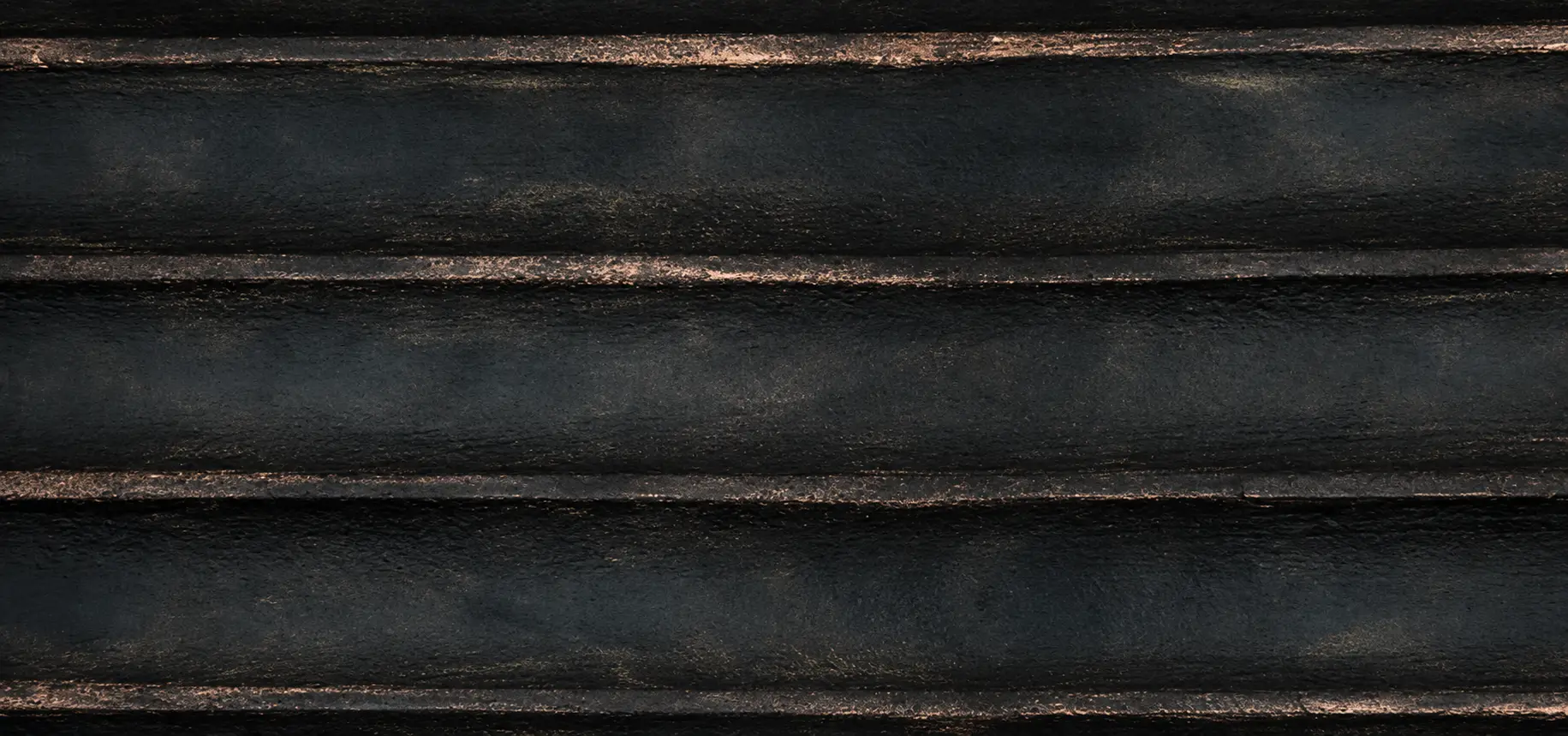 Close-up of YITA Obsidian Gold flexible stone with black horizontal texture and subtle gold highlights