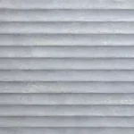 Light silver gray surface with layered horizontal stone-like ridges