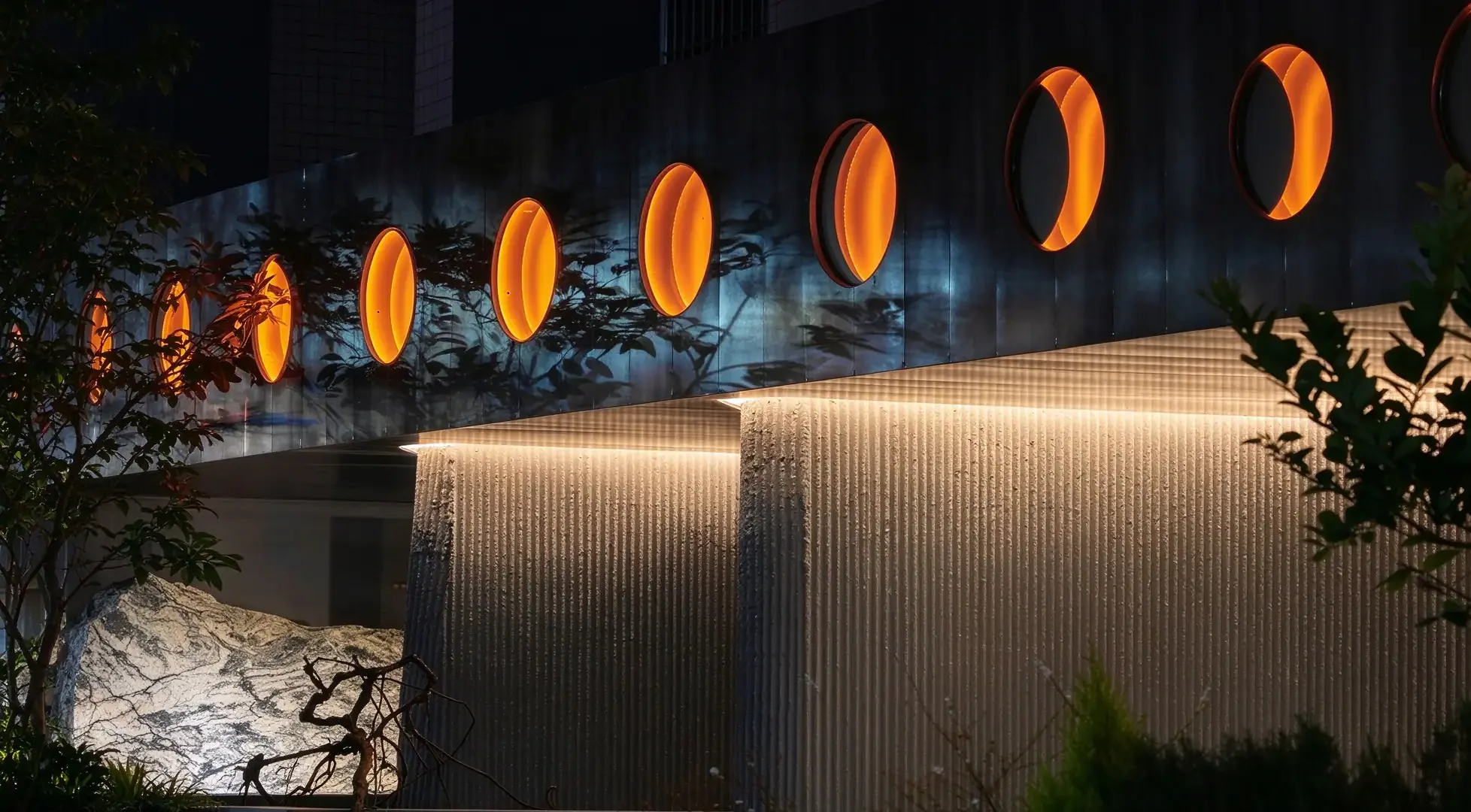 Flexible Stone for Bar Projects —Nighttime facade details of the Wine Nuts restaurant and wine bar in Singapore, featuring MCM flexible stone cladding with a linear veined texture