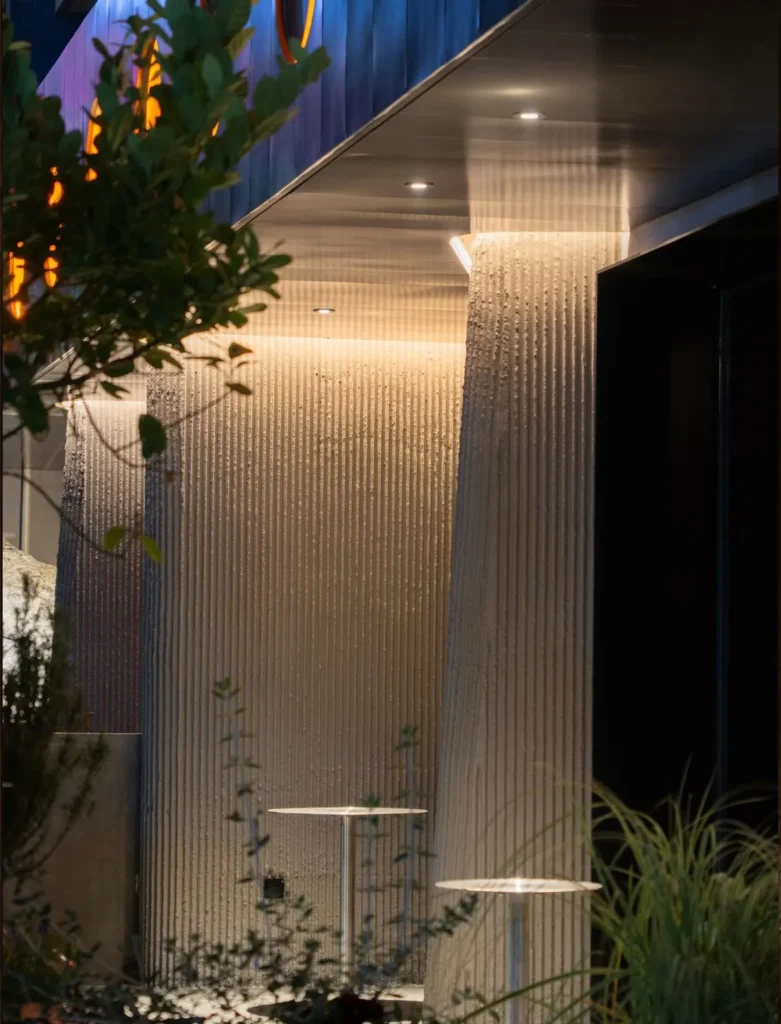 Vein stone textured MCM flexible stone veneer interior wall for Wine Nuts wine bar and restaurant, intimate dining area with warm amber lighting
