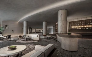 Completed hotel lobby featuring stone-look flexible cladding on cylindrical columns, curved reception counter and interior walls.